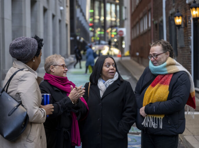 A group of four people talking